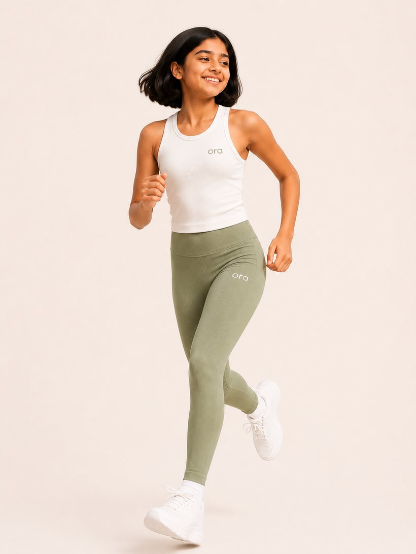 Tween in Ora rib tank and hybrid leggings, running