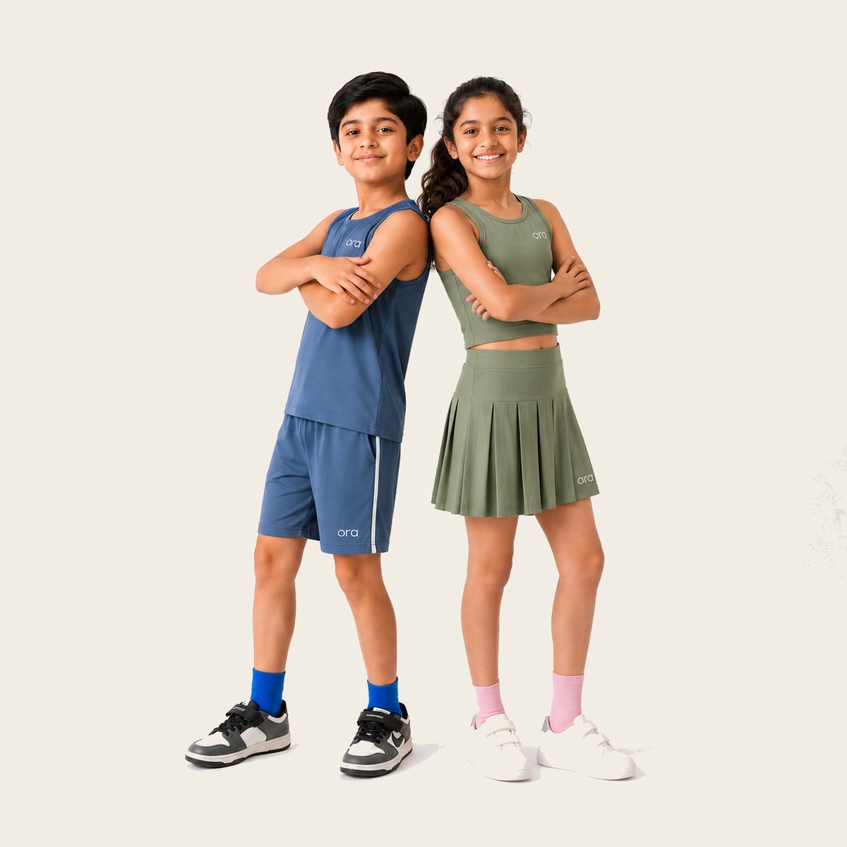 Two tweens in Ora activewear, standing back to back